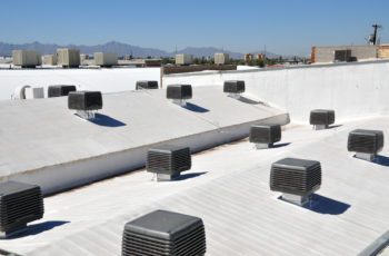 multiple evaporative cooling units installed in the roof of a factory