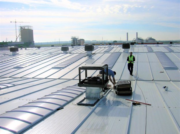 HVAC Service Staff on Industrial Plant Rooftop Servicing Evaporative Air Conditioners