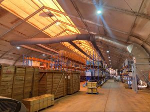 Commercial HVAC system using fabric ducting in a large warehouse facility